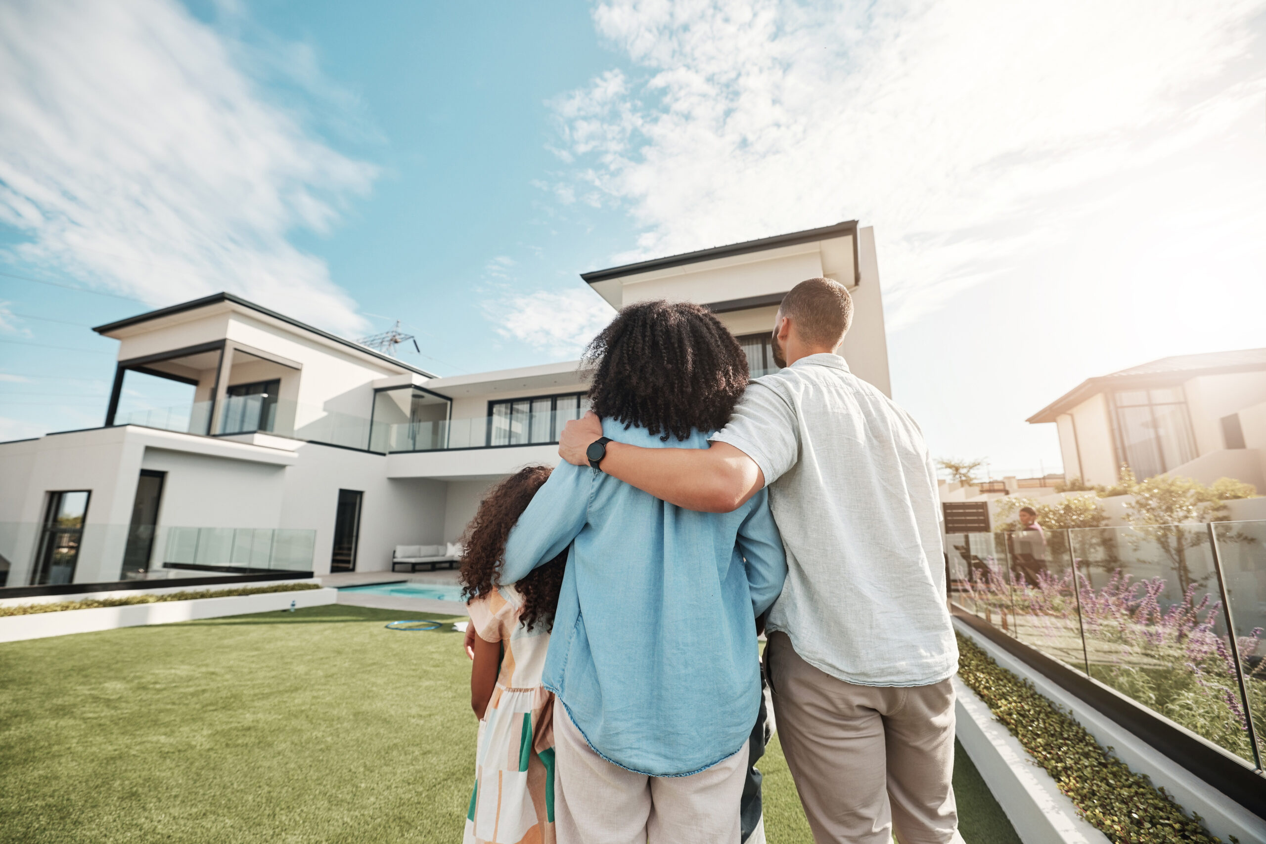 love new home family standing their backyard looking their property luxury real estate embrace mortgage parents with their children grass their house mansion canada